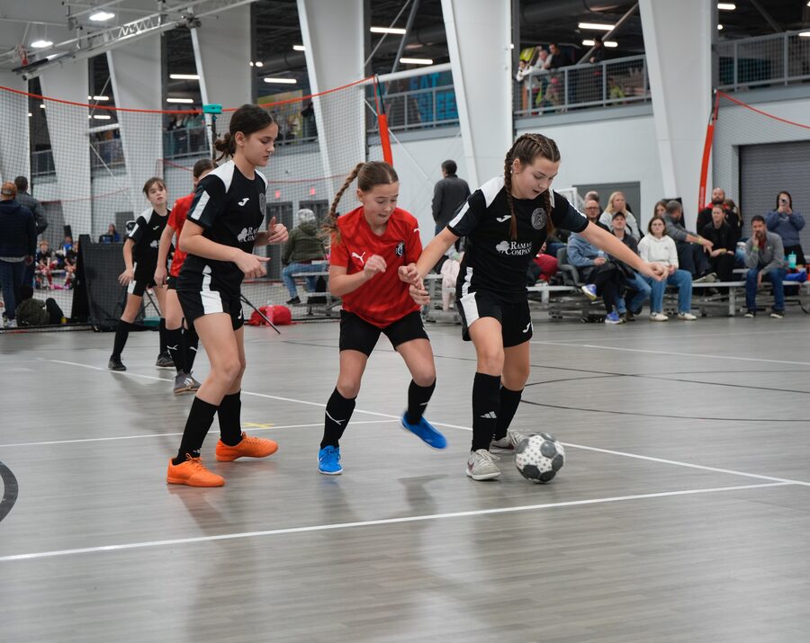 FDA girls team defending in a futsal match