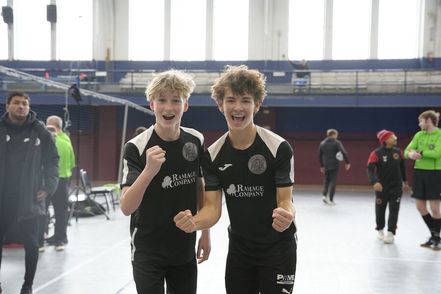 Two FDA players celebrating a goal with clenched fists