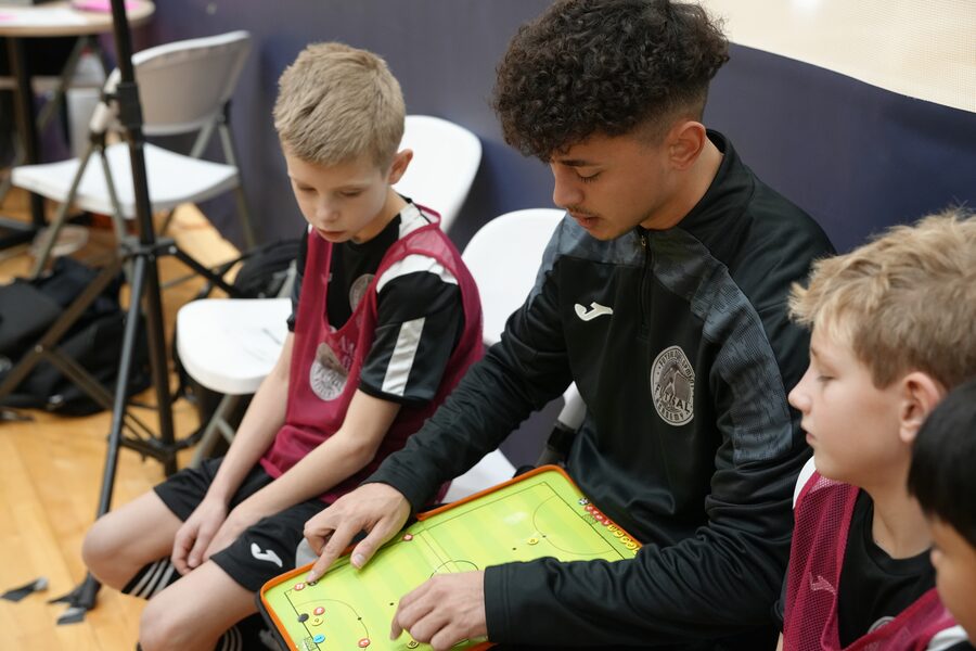 Coach walking players through a play on a tactics board