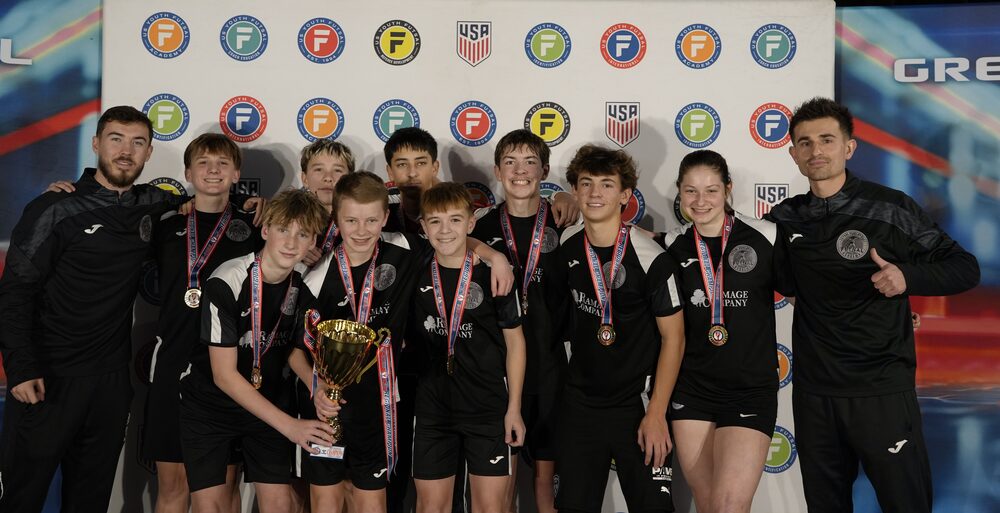 FDA academy team and coaches with medals and a trophy at a US Youth Futsal tournament