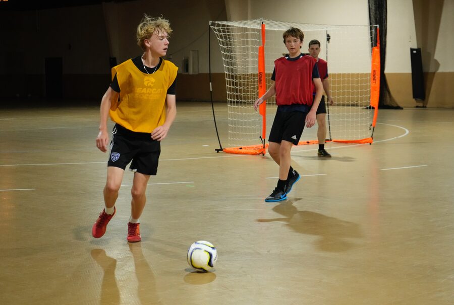 Players in yellow and red bibs in a small-sided training game